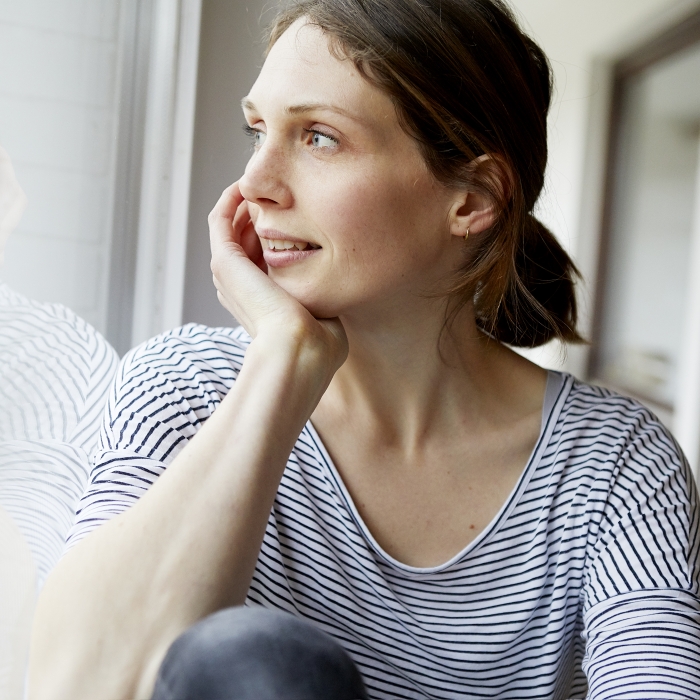 Woman looking out window – Crisis Supporter