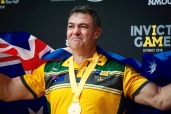 sportsman wearing medal and australian flag 