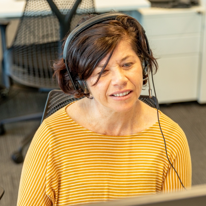 Crisis supporter wearing a headset and microphone, attentively providing support