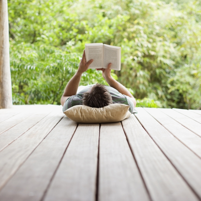 Man reading a book in a relaxed setting