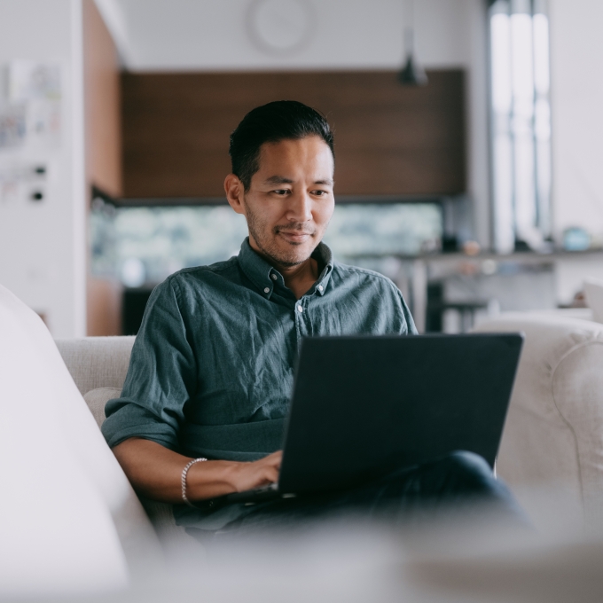 Man sitting on laptop in relaxed setting