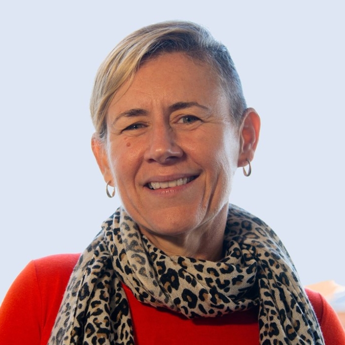 woman smiling and wearing a scarf and red sweater
