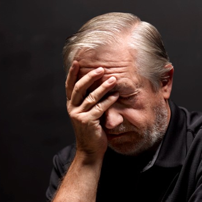 man holding head in palm of hand